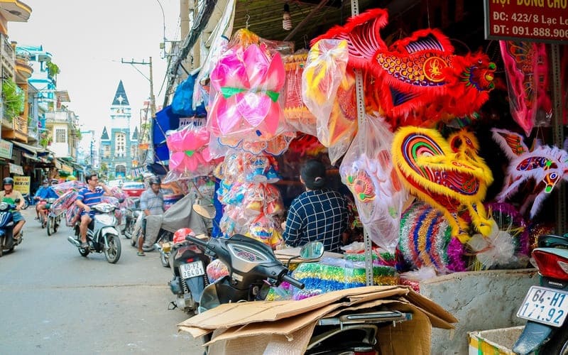 Vendors sell lanterns on the street leading to Phu Binh Village