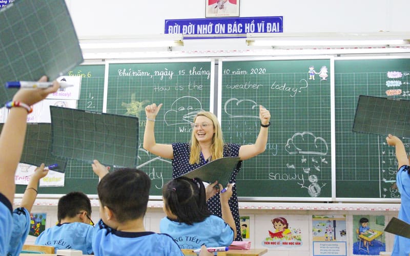 A teacher eagerly interacts with her students