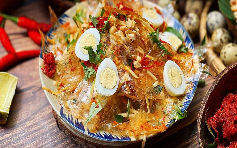 Each bag of this affordable mixed rice paper is packed with dried beef, dried shrimp, quail eggs, shredded mango, Vietnamese coriander, roasted peanuts, shrimp salt