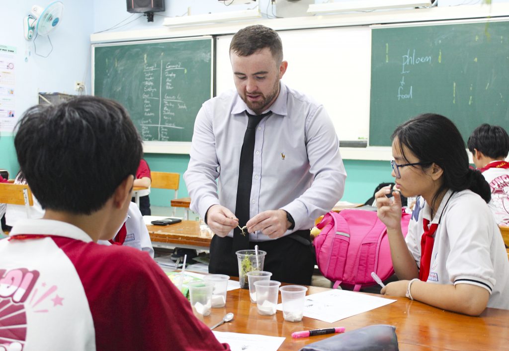Teacher delivering a biology lesson in English to secondary school students in an Integrated English class by EMG Education