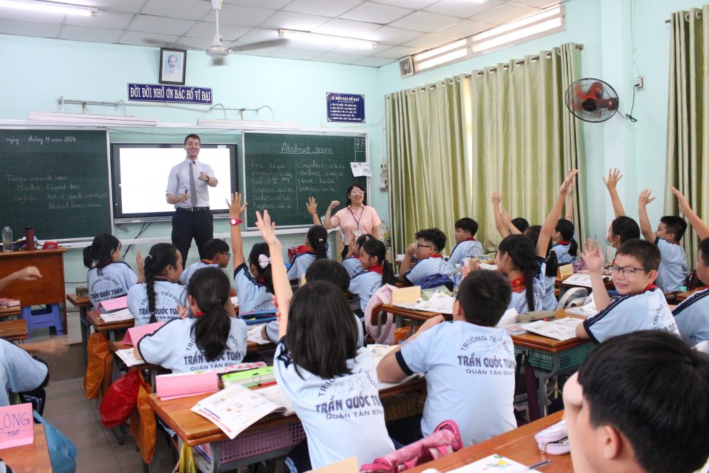 Teacher delivering an English lesson to secondary school students in an EMG Education class